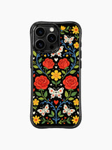 PhoneCasing iPhone 16 pro max Case with winding blue vines, sugar skull butterflies and red roses, interspersed with yellow flowers and tiny hearts, folk art print on durable black iPhone 16 pro max casing.