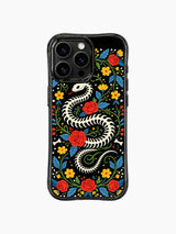 PhoneCasing iPhone 16 pro max Case featuring a bone snake skeleton coiled into a wreath, surrounded by whimsical folk flowers and leaves in vibrant colors, creating a playful Day of the Dead look on black iPhone 16 pro max casing.
