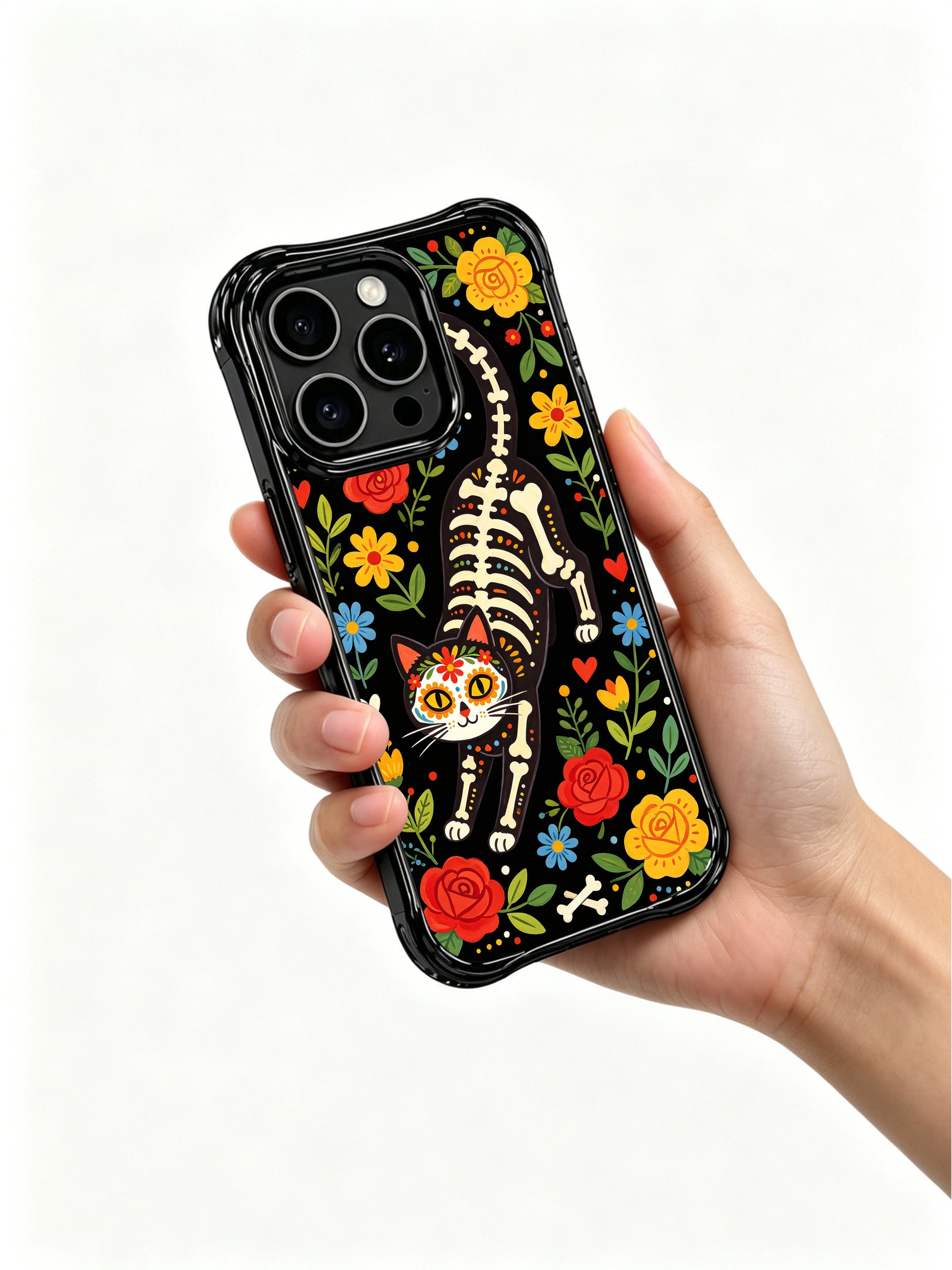 PhoneCasing iPhone 16 pro max Case featuring a front-facing floral skeleton cat framed by full bloom roses and wildflowers, Día de los Muertos folk art with sugar skull face, premium anti-drop iPhone 16 pro max casing.