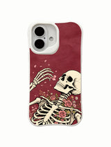 Close-up skeleton hand and pink petal ink-style detail on an iPhone 16 case