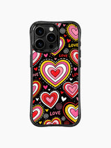 PhoneCasing iPhone 13 Pro Max casing plain matte black background that makes pink red yellow candy heart layers glow vividly, balanced sugary sweet everyday statement phone cover.
