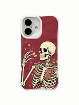 Skeleton with wind-drifting pink petals on an iPhone 16 case