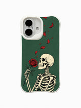 PhoneCasing Emerald Rose Letter fine art iPhone 16 Case, original Morrigan Vale old-school goth tattoo design featuring side-profile skeleton holding single red rose with drifting scarlet petals on vintage deep emerald green backdrop, scratch resistant glossy iPhone 16 casing crafted in California