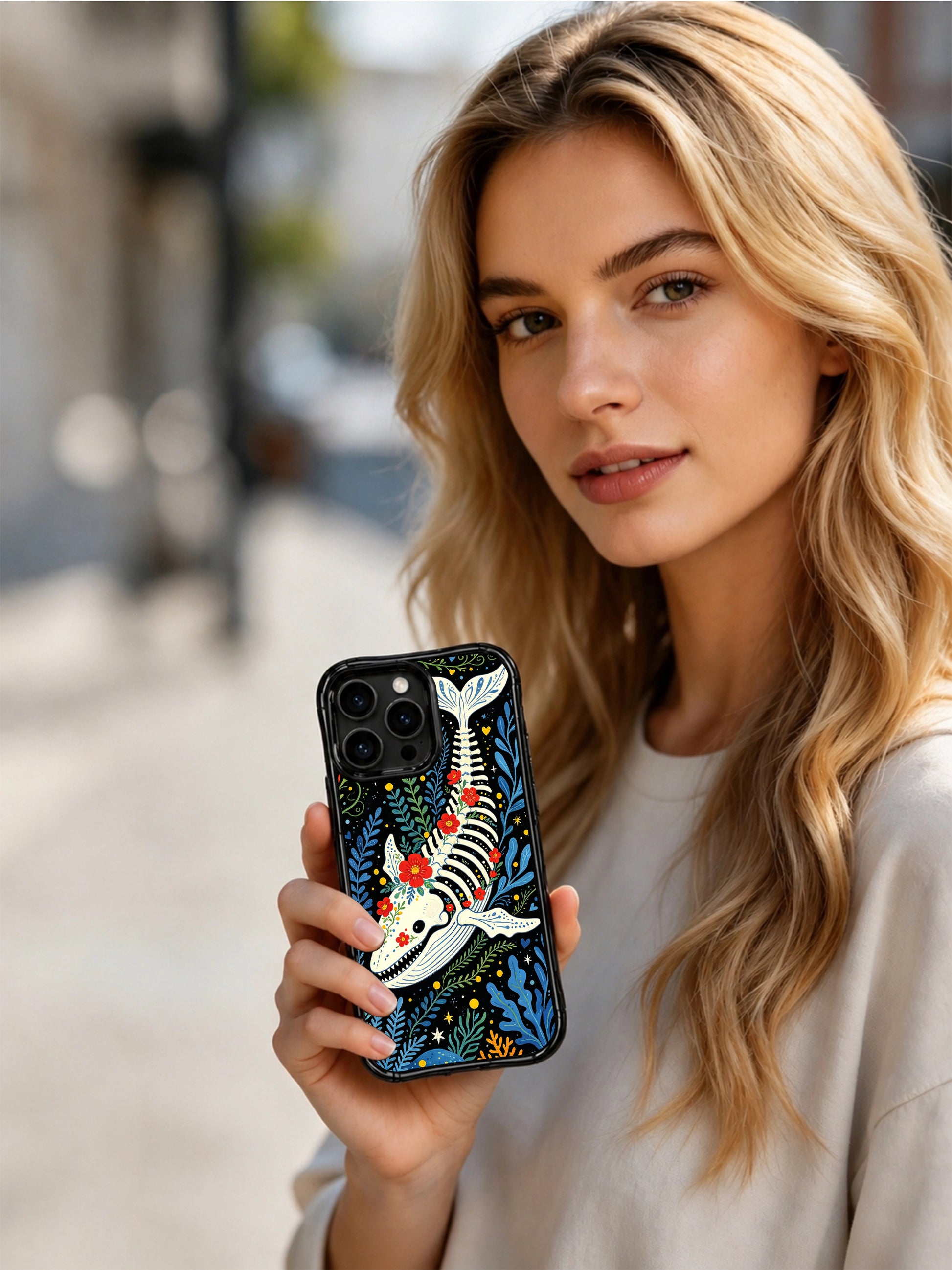PhoneCasing iPhone 16 pro max anti-drop case with a folk art whale motif. Whimsical underwater garden design with flowers and skeleton details.