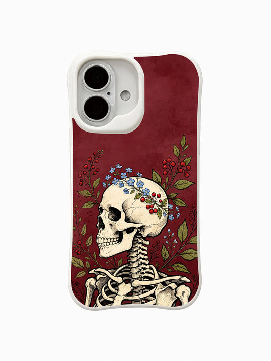 PhoneCasing Forget-Me-Not Cranium fine art iPhone 16 Case, Morrigan Vale old-school goth tattoo artwork with blue forget-me-not wreath & red berry on distressed burgundy background, scratch resistant glossy casing crafted in California