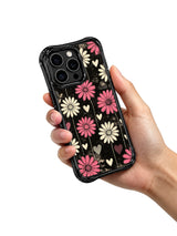 PhoneCasing iPhone 16 pro Case with high contrast distressed black background blush pink & cream vertical daisy print, Ruby Daze Pink Static Garden artist-designed wavy casing for cool feminine style.