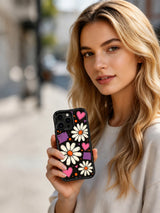 PhoneCasing iPhone 16 pro Case with glowing hot pink hearts and orange halftone splatters, part of Ruby Daze’s Midnight Daisy Pulse Collection, UV-printed wavy art casing.