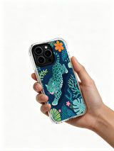 Blue spotted cat framed by indigo sea foliage artwork on an iPhone 13 Pro case