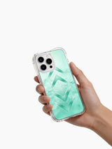 A hand holding the mint geometric arrow case.