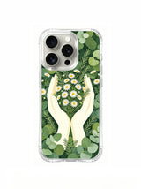 Hands holding daisies artwork on an iPhone 15 Pro case