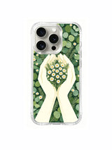 Soft green hands holding daisies artwork on an iPhone 15 Pro case