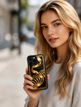 PhoneCasing iPhone 15 pro max case from the Wild Gilded Safari collection, black gold jungle ribbon design by artist Aurelia Wilden.