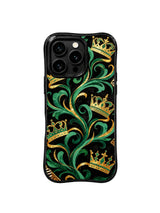 PhoneCasing iPhone 15 pro max cover in natural light, showing metallic gold crown sheen against emerald and black, luxury regal phone case.