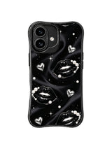 PhoneCasing iPhone 16 case featuring luxe black kiss artwork with pearls, silver hearts, and star-like details on a smooth dark background.