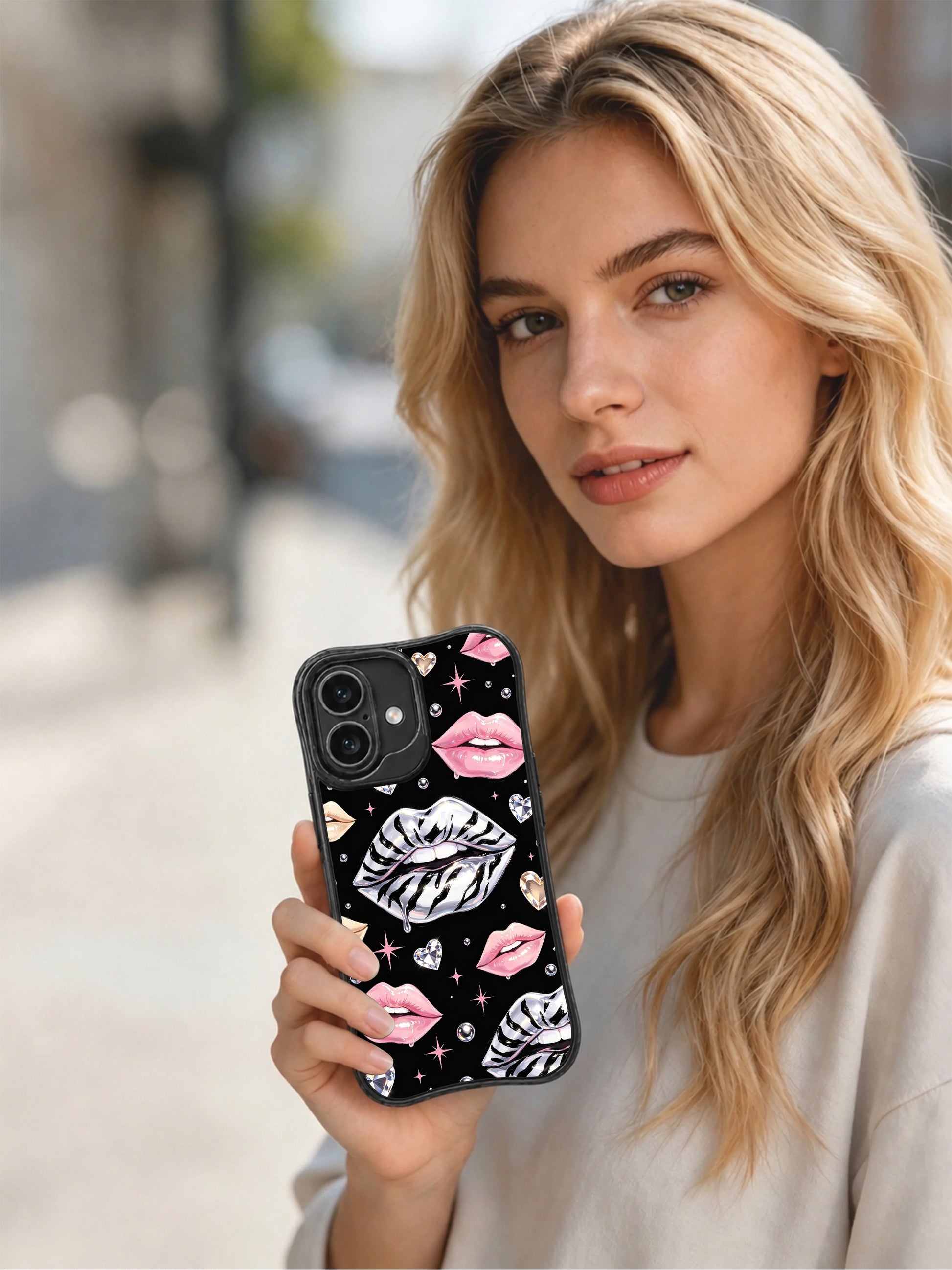 PhoneCasing iPhone 16 case from Midnight Kiss Glam Collection with zebra-striped silver lips, glossy pink lips, and diamond heart details.