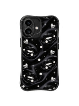 PhoneCasing iPhone 16 case featuring Pearl Noir Kiss artwork with glossy black lips, pearl details, silver hearts, and a black satin-inspired background.
