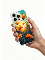 PhoneCasing Aurora Bloom Twilight Wildflower iPhone 16 Pro Max Case, where orange blooms meet a gradient teal and gold sky.