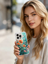 PhoneCasing Teal and Coral Poppy Floral iPhone 16 Pro Max Case, featuring vibrant flowers against a serene coastal background.