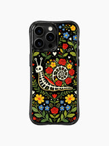 Colorful folk art skeleton snail artwork on this PhoneCasing iPhone 16 pro max case, featuring a snail skeleton surrounded by roses and hearts.