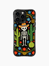 PhoneCasing iPhone 16 pro max case featuring a whimsical Day of the Dead skeleton in a sombrero, surrounded by cacti and colorful flowers on black background.