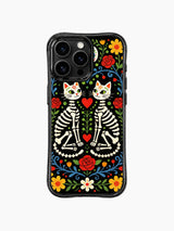 PhoneCasing iPhone 16 pro max case featuring twin skeleton cats with sugar skull faces, vibrant folk art design with red roses and colorful flowers on black background.