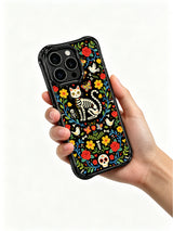 Gothic folk art skeleton cat on this PhoneCasing iPhone 16 pro max case, featuring sugar skull details and vibrant floral patterns.