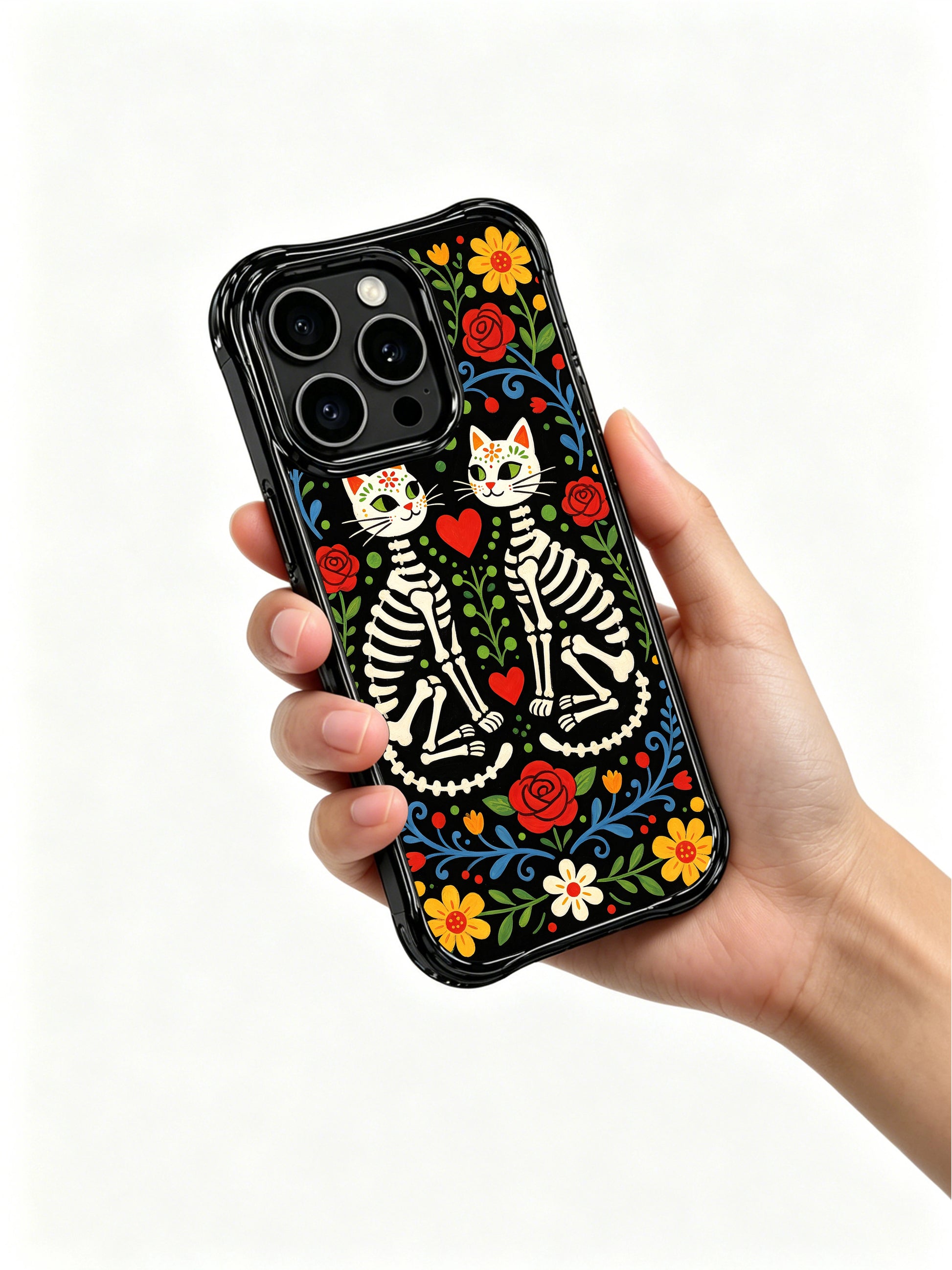 Twin skeleton cats with red hearts on this PhoneCasing iPhone 16 pro max case, folk art style with sugar skull faces and floral details.