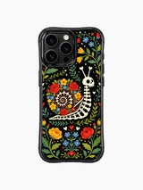 Skeleton snail in a Day of the Dead floral garden on this PhoneCasing iPhone 16 pro max case, featuring roses and folk art details.