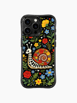 Vibrant skeleton snail on this PhoneCasing iPhone 16 pro max case, folk art style with roses, hearts, and colorful blooms.