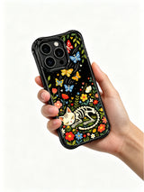 Whimsical night garden skeleton cat design on PhoneCasing iPhone 16 pro max case, featuring a cat with bone butterflies and vibrant flowers.
