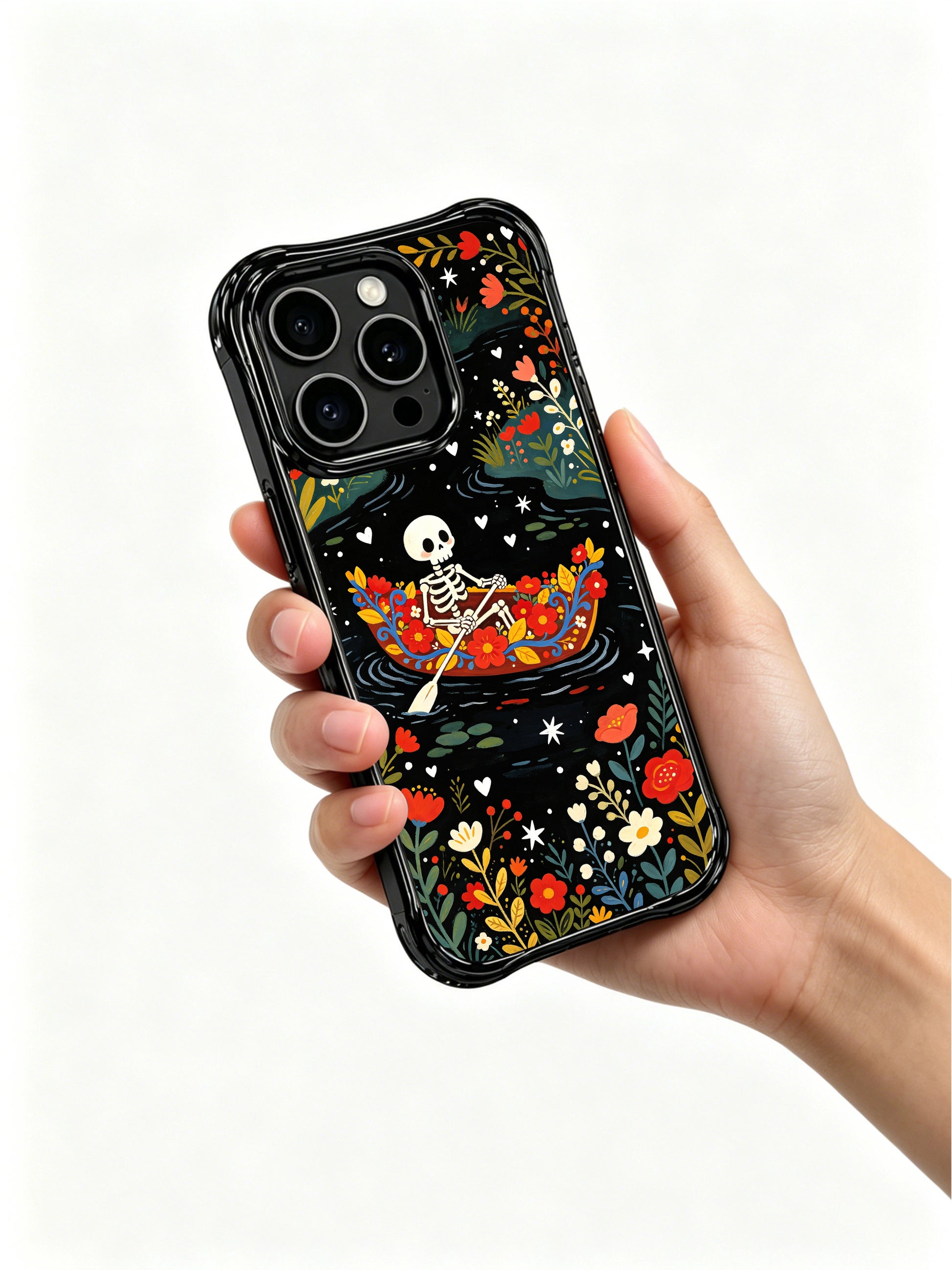Whimsical skeleton in a floral boat design on PhoneCasing iPhone 16 pro max case, featuring stars and hearts on a dark background.