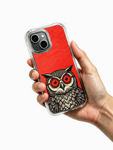 Hand holding the red-lens owl case