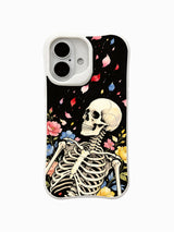 PhoneCasing Night Petal Rain fine art iPhone 16 Case, original Morrigan Vale watercolor goth tattoo artwork featuring upright skeleton with falling multicolor flower petals landing on skull and shoulder against vintage black background, scratch resistant glossy casing made in California