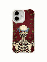 PhoneCasing lifestyle handheld Forget-Me-Not Cranium iPhone 16 Case, female model holding goth skull floral artwork outdoors, slim lightweight scratch resistant glossy iPhone 16 cover