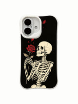 PhoneCasing lifestyle handheld Midnight Rose Letter iPhone 16 Case, female model holding traditional goth skeleton red rose artwork outdoors, slim lightweight scratch resistant glossy iPhone 16 cover