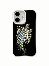 PhoneCasing lifestyle handheld Star Blossom In Bone iPhone 16 Case, female model holding traditional goth rib skeleton glowing blue flower artwork outdoors, slim lightweight scratch resistant glossy iPhone 16 cover