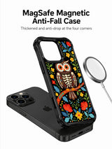 PhoneCasing iPhone 16 pro max Case with a folk-art skeleton owl whose eyes are like blooming flowers, perched on a branch surrounded by red, yellow and blue blooms, folk art print on durable black iPhone 16 pro max casing.