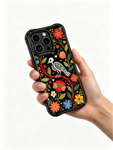 PhoneCasing iPhone 16 pro max Case featuring a skeleton bird centered within a symmetrical folk floral border of red, blue and yellow blooms, balanced folk art design for iPhone 16 pro max casing.