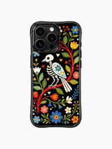PhoneCasing iPhone 16 pro max Case with a skeleton bird whose wings are decorated with intricate blue and yellow folk flowers, perched on a red branch surrounded by colorful blooms, whimsical folk design on iPhone 16 pro max casing.