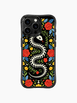 PhoneCasing iPhone 16 pro max Case with a bone snake skeleton coiled into a wreath, surrounded by traditional folk art flowers and leaves in red, yellow and blue, Day of the Dead inspired print on black iPhone 16 pro max casing.