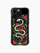 PhoneCasing iPhone 16 pro max Case with a bone snake skeleton framed by a border of red roses, yellow flowers and blue leaves, creating a symmetrical folk art design on iPhone 16 pro max casing.