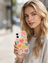 PhoneCasing soft peach heart daisies iPhone 16 plus case, gentle pastel heart pattern with tiny daisy blooms, UV-printed printing.