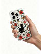 Black cat beneath crescent eye with two lipstick daggers artwork on an iPhone 15 Pro case