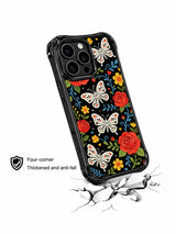 PhoneCasing iPhone 16 pro max Case with a symmetrical arrangement of sugar skull butterflies, red roses and blue vines, surrounded by yellow flowers and small hearts, balanced folk art pattern on black iPhone 16 pro max casing.