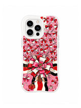Pink Ribbon Flower Field pattern on a white iPhone 14 Pro case with many small pink bow blossoms, a large ribbon flower, red gifts and black ink accents