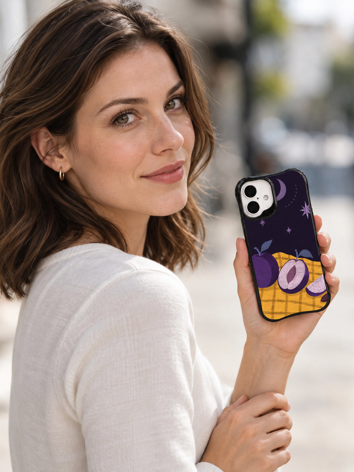 Lifestyle view of The Plum Observatory black iPhone 16 case