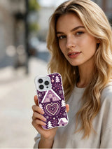Lifestyle view of The Plumberry Winter Village iPhone 13 Pro case with plum folk chalet design