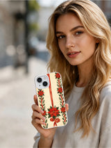 Person holding the Poinsettia Ribbon Columns iPhone 15 case
