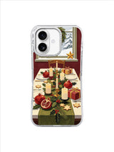 Holly candle centerpiece with pomegranates, plates, and gifts on an iPhone 17 case