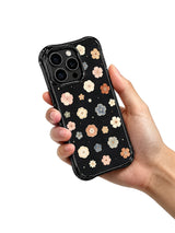 Quiet Floral Manuscript iPhone 15 Pro case held in hand